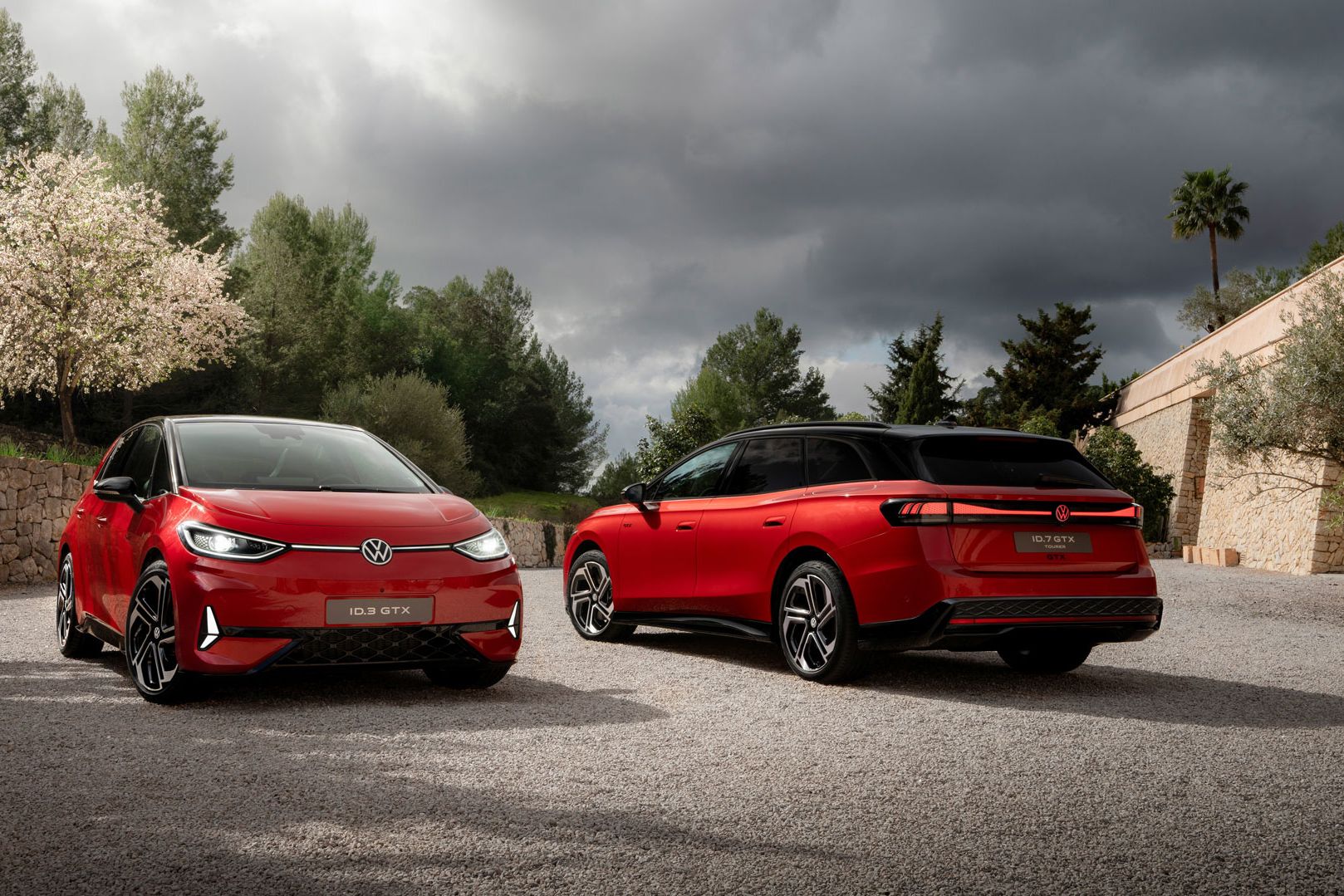 Ein roter VW ID.7 Tourer GTX und ein ID.3 GTX stehen auf einem Parkplatz. 