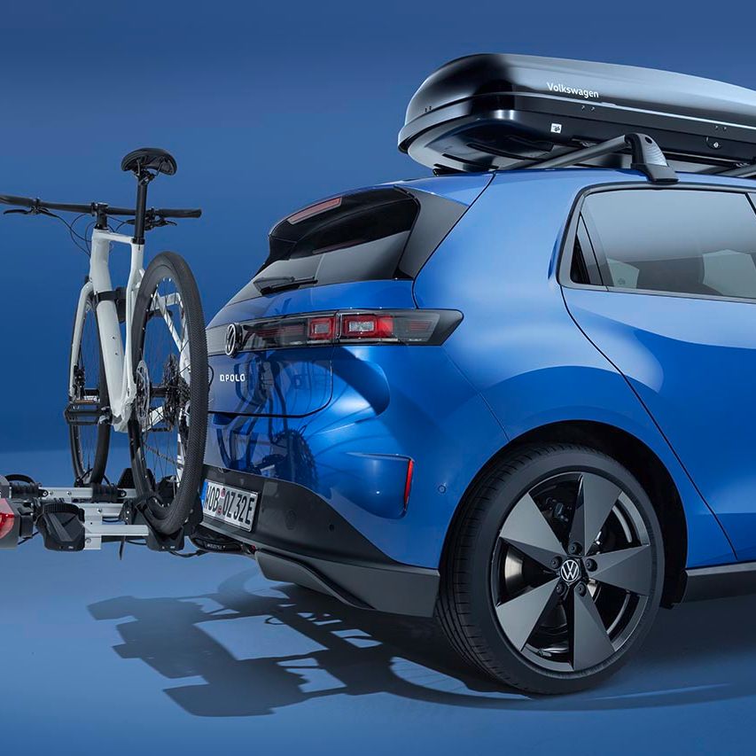 Ein blauer Volkswagen ID. Polo mit Dachbox und Fahrradheckträger.
