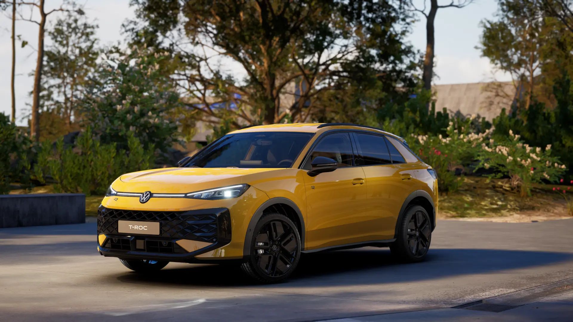 Gelber T-Roc R-Line, geparkt auf einer Straße bei Tageslicht. Der SUV hat ein modernes Design mit schwarz akzentuierten Rädern. Im Hintergrund sind grüne Bäume und Pflanzen zu sehen.