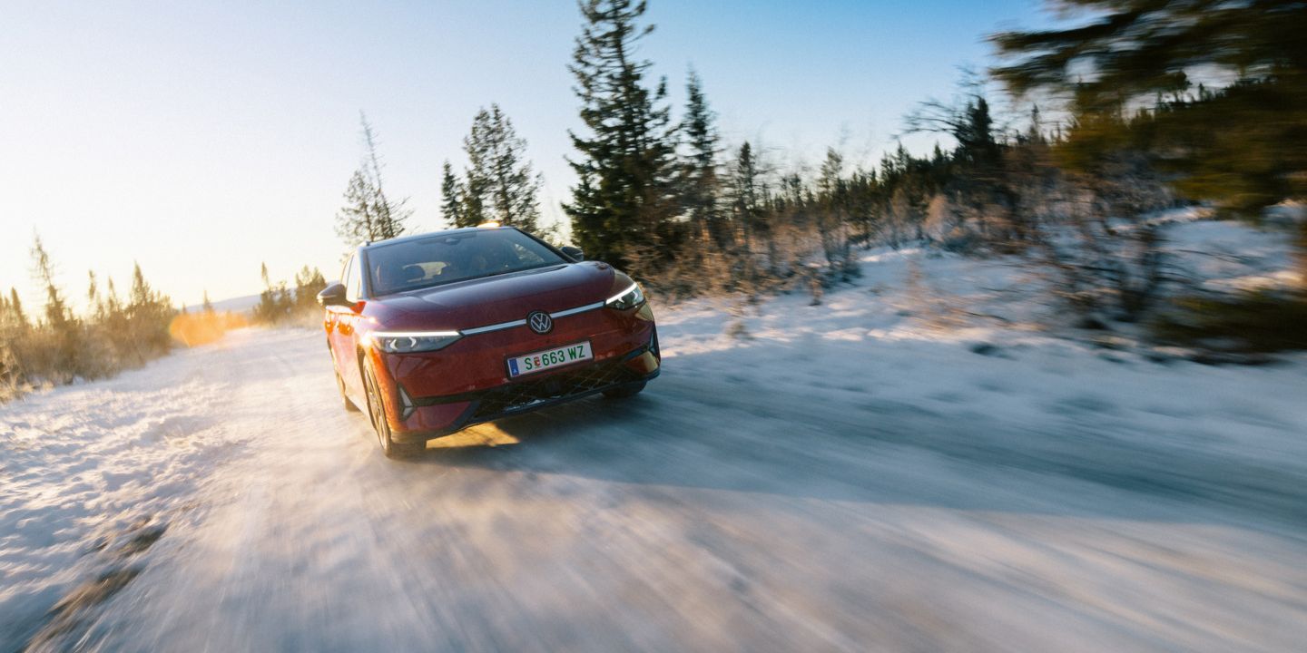 Ein roter ID.7 Tourer GTX fährt eine Landstraße entlang. 