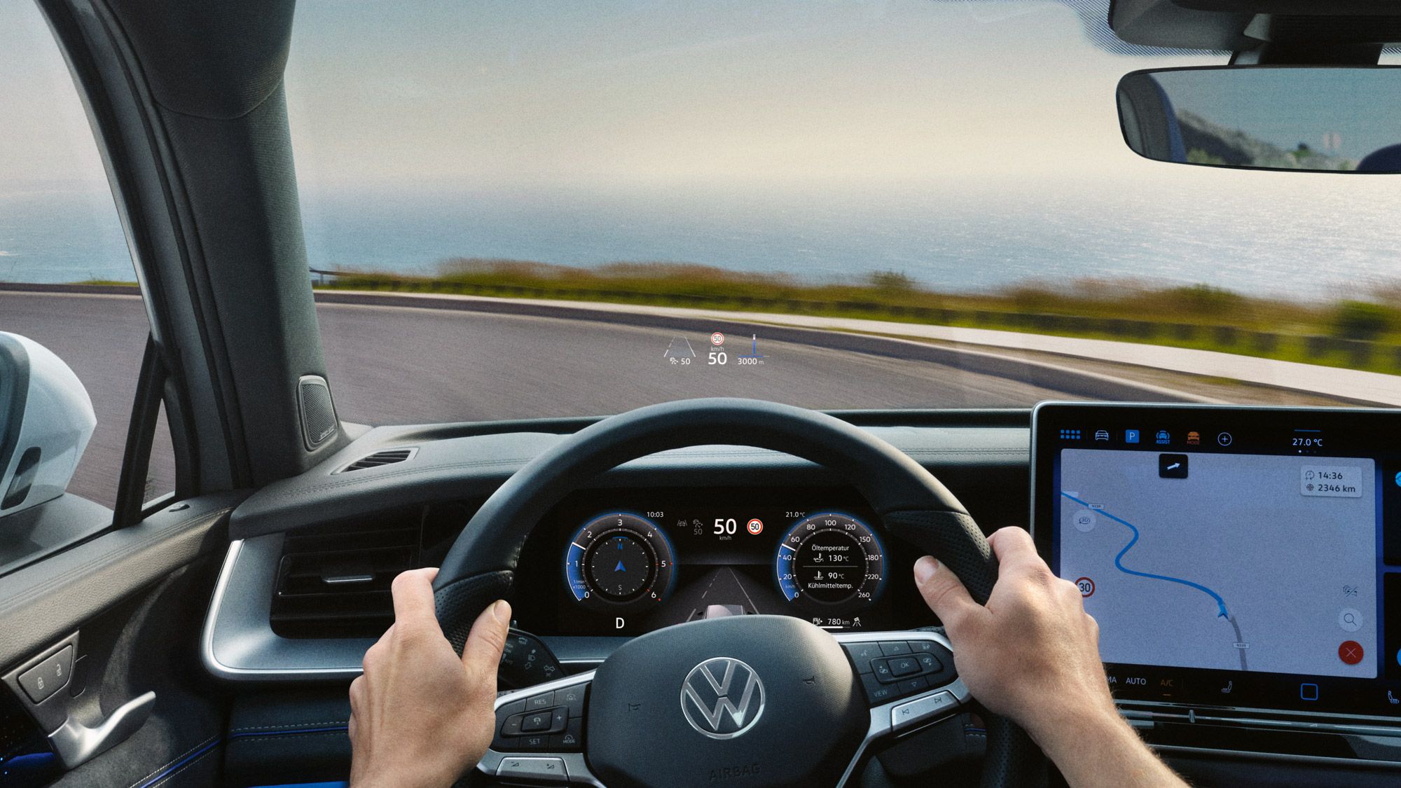 Blick auf das Head-up-Display, Lenkrad und Navigationssystem des VW Tayron während der Fahrt.
