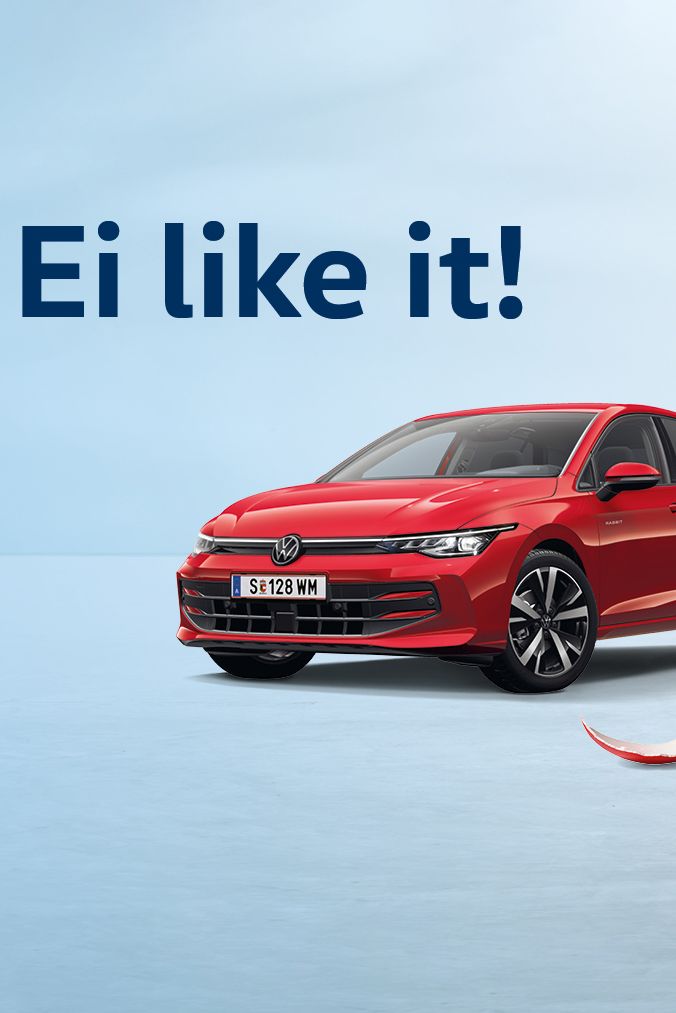 Ein Hase steht vor dem neuen Golf Rabbit in Kings Red Metallic