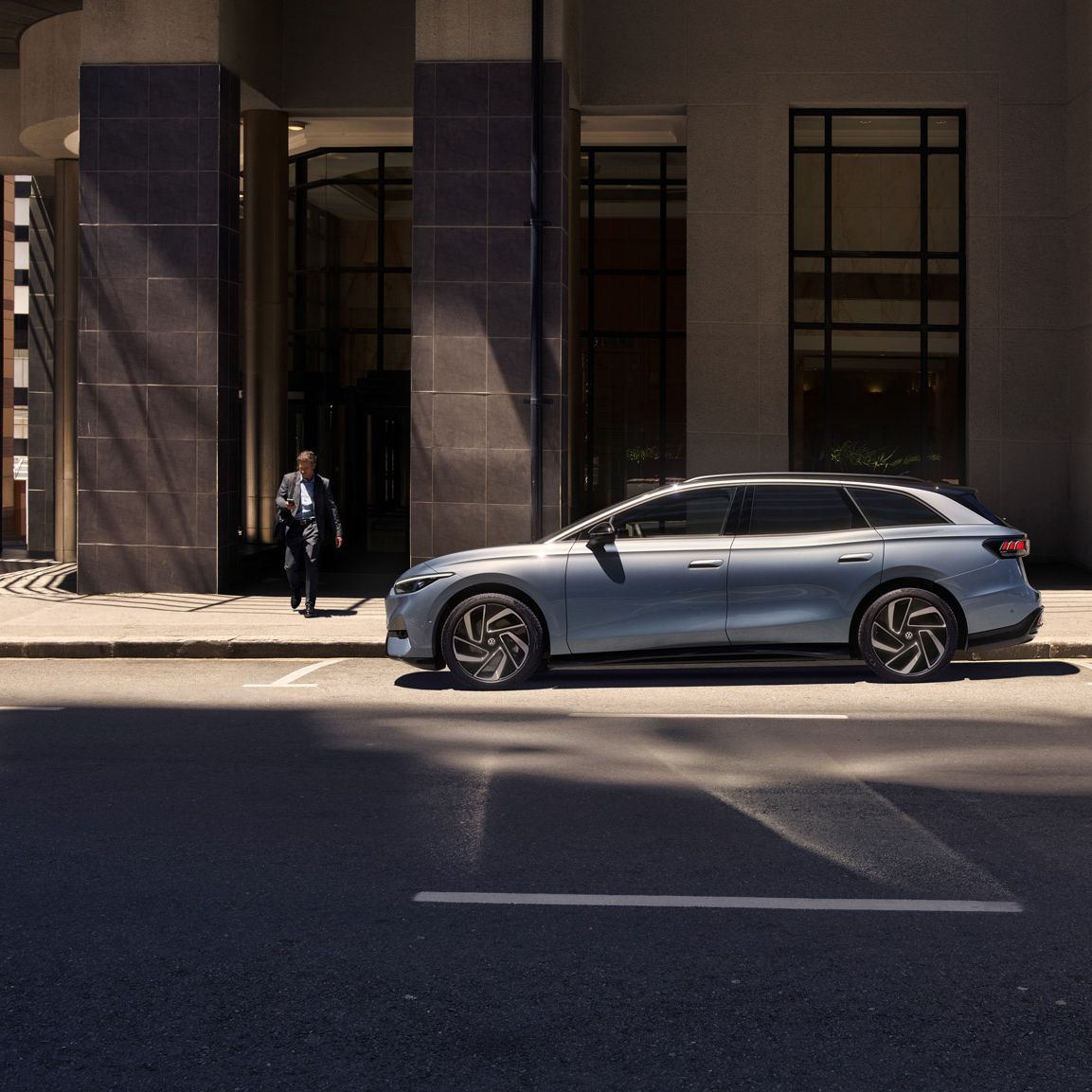 Der ID.7 Tourer steht am Straßenrand in der Stadt vor einem Gebäude