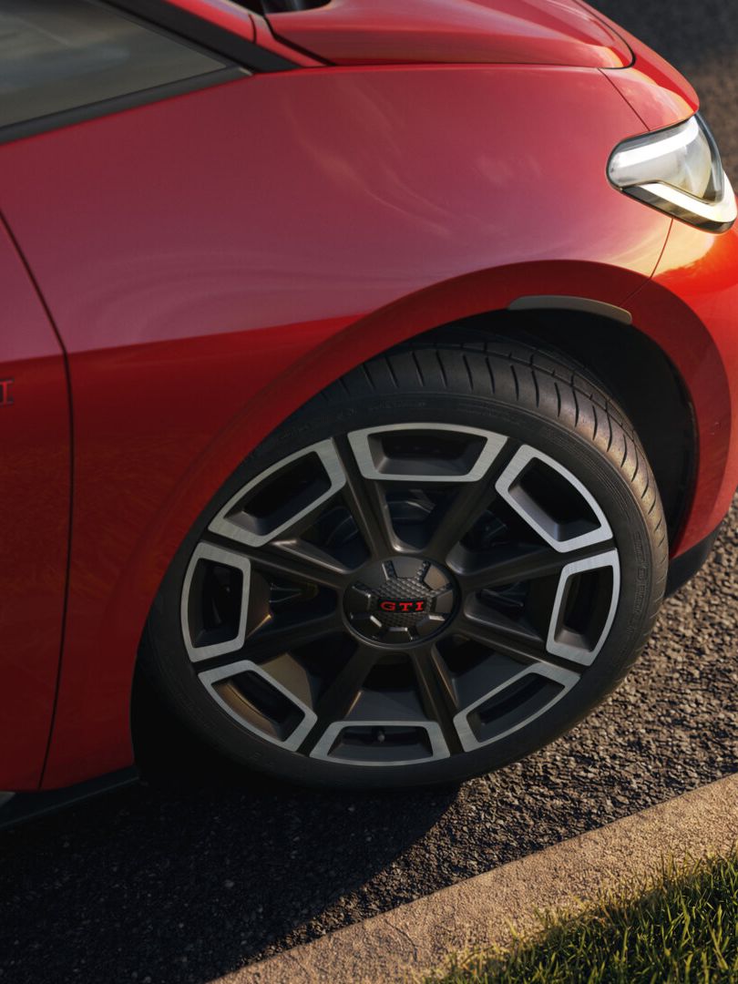 [AI-modified] – Detailansicht der Felge eines roten VW ID.3 GTI.