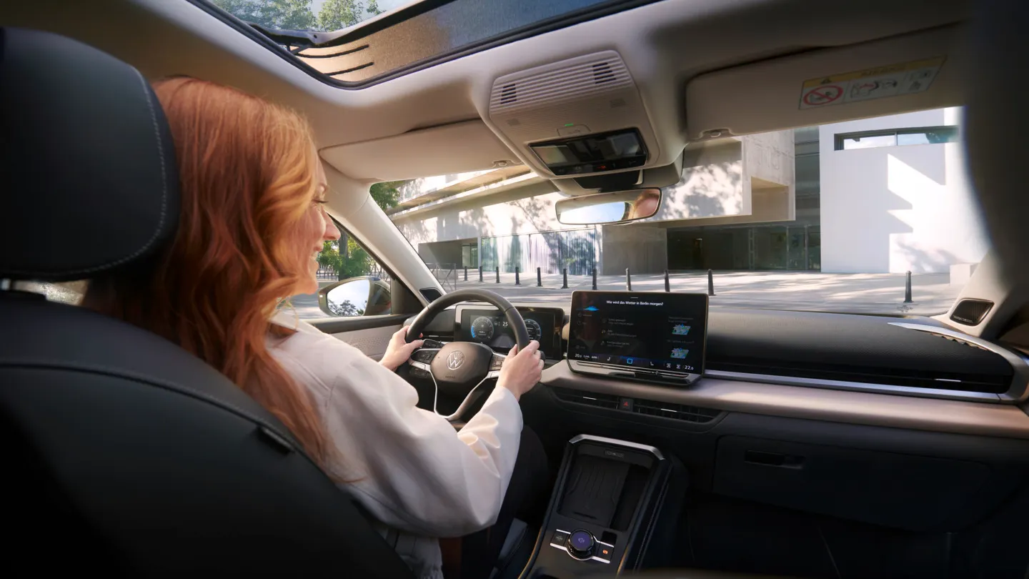 Eine Frau nutzt die Sprachsteuerung IDA im VW T-Roc Style.
